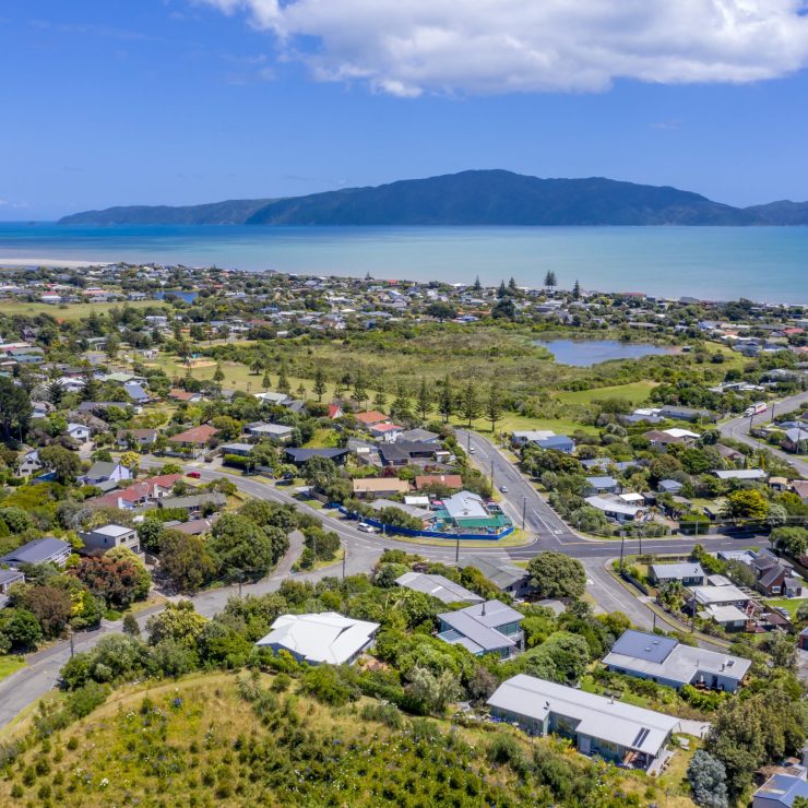 a panoramic shot of a coastal town under blue skies